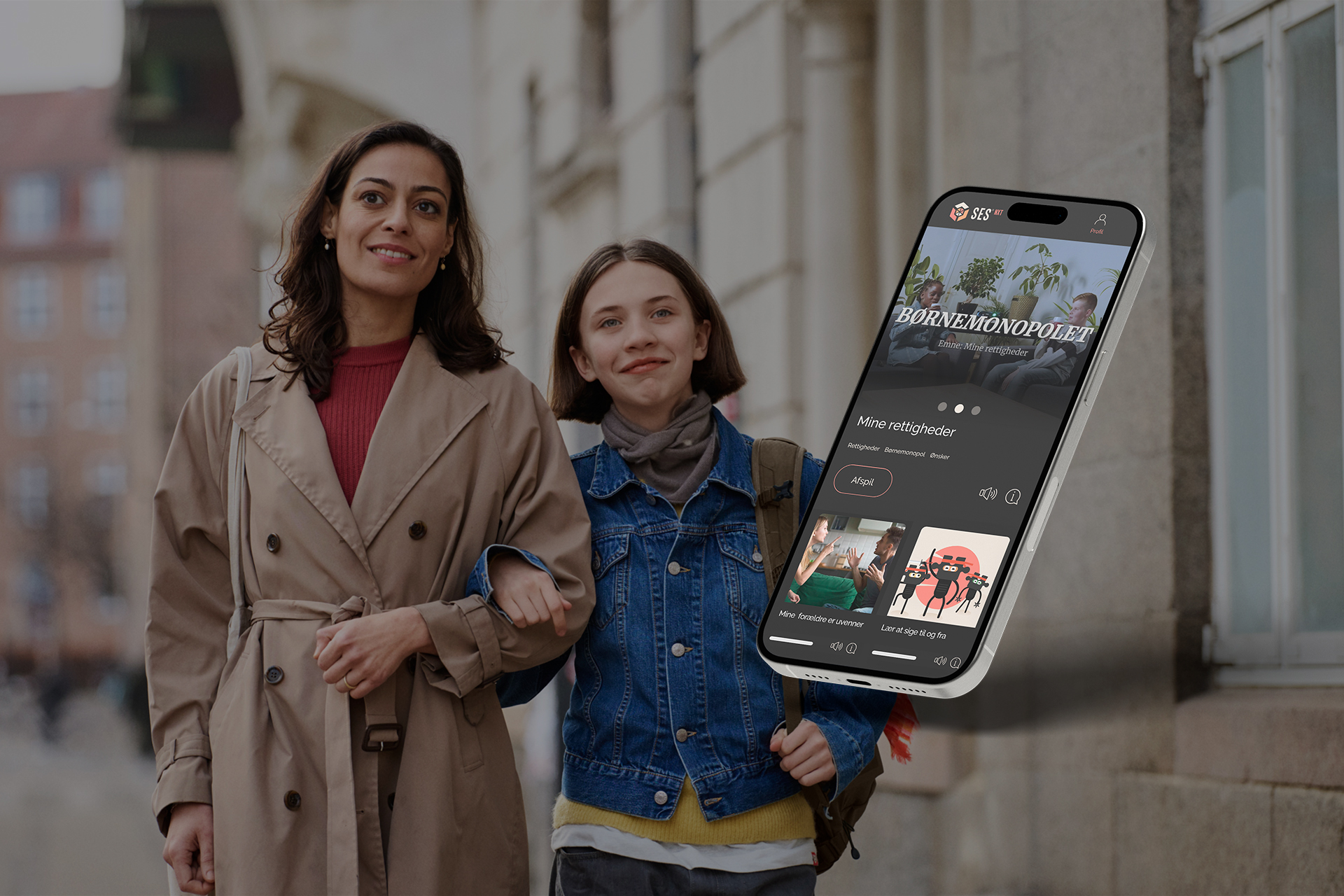 Woman and child walking down a street with interlocked arms, with a phone showing the SES website in the foreground